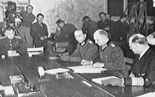 General Alfried Jodl signs an unconditional German surrender
