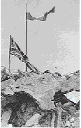 Polish troops raise their flag over the ruined monastery